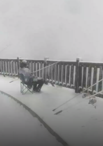 大连一男子顶着大雪钓鱼 究竟是什么情况